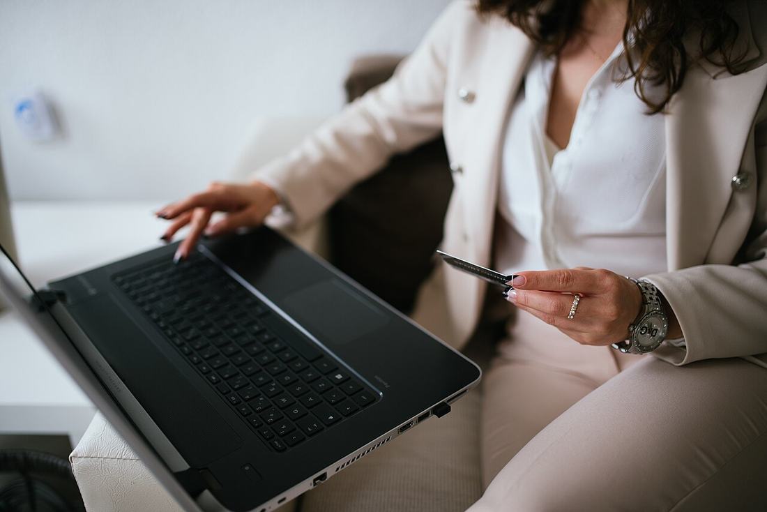 best free tools for online sellers india - person in business attire working on a laptop while holding a card 2026